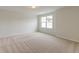 Spacious carpeted bedroom filled with natural light from a large window at 2582 Kingsfield St, Mount Pleasant, SC 29466