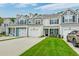 Inviting townhomes with colorful siding, attached garages, and well-maintained lawns on a sunny day at 2582 Kingsfield St, Mount Pleasant, SC 29466