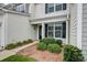Close-up of the front entrance with a black door, large window, and neatly trimmed landscaping at 2582 Kingsfield St, Mount Pleasant, SC 29466