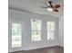 Bright living room with hardwood floors, large windows, and a ceiling fan, offering a relaxing and inviting atmosphere at 2582 Kingsfield St, Mount Pleasant, SC 29466