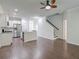 Open-concept living room featuring a kitchen with stainless steel appliances and staircase to the upper level at 2582 Kingsfield St, Mount Pleasant, SC 29466