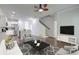 Open-concept living room featuring a kitchen with stainless steel appliances and staircase to the upper level at 2582 Kingsfield St, Mount Pleasant, SC 29466