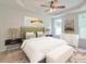 Well-lit main bedroom with large windows, a ceiling fan and neutral décor for a calming atmosphere at 2582 Kingsfield St, Mount Pleasant, SC 29466