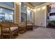 Inviting back porch with wicker chairs, string lights and view of the home's interior at 2582 Kingsfield St, Mount Pleasant, SC 29466