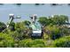 Aerial image highlights a house with a private dock, nestled among lush trees, offering direct water access at 2619 Buccaneer Rd, Isle of Palms, SC 29451