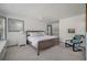 This bedroom has an area for storage and a queen bed facing a window and ceiling fan for added comfort at 2619 Buccaneer Rd, Isle of Palms, SC 29451