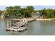 Waterfront home featuring a private boat dock, covered boat lift, and deck space for enjoying the serene views at 2619 Buccaneer Rd, Isle of Palms, SC 29451