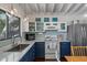 Charming kitchen with updated appliances, blue cabinets, marble countertops, and backsplash at 2619 Buccaneer Rd, Isle of Palms, SC 29451