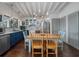 Stylish kitchen and dining area featuring stainless steel appliances, blue cabinets, and modern lighting fixtures at 2619 Buccaneer Rd, Isle of Palms, SC 29451