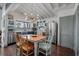 Modern kitchen and dining area with stainless steel appliances, custom cabinets, and ample natural light at 2619 Buccaneer Rd, Isle of Palms, SC 29451