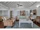 Cozy living room with vaulted ceilings, wicker furniture, and a ladder leading to a loft at 2619 Buccaneer Rd, Isle of Palms, SC 29451