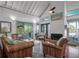Inviting living room with wicker furniture and access to a screened-in porch with a lovely view at 2619 Buccaneer Rd, Isle of Palms, SC 29451