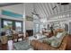 Open-concept living room flowing into the kitchen with wicker furniture and a charming fireplace at 2619 Buccaneer Rd, Isle of Palms, SC 29451