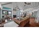 Bright living room featuring a vaulted ceiling, fireplace, hardwood floors, and an open layout to the kitchen at 2619 Buccaneer Rd, Isle of Palms, SC 29451