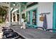 Charming outdoor patio featuring a large wooden table, seating for ten, and inviting blue doors in coastal style at 2619 Buccaneer Rd, Isle of Palms, SC 29451