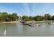 Waterfront property with a private dock extending into the water under a clear blue sky at 2619 Buccaneer Rd, Isle of Palms, SC 29451