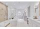 Bright, spacious bathroom featuring a freestanding tub, glass shower, and double vanity with marble countertops at 27 Watroo Pt, Daniel Island, SC 29492