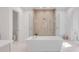 Luxury bathroom with a freestanding tub, large glass shower, and a double vanity with marble countertops at 27 Watroo Pt, Daniel Island, SC 29492
