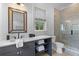 Bathroom with dark gray vanity, quartz counters, glass shower, and dark fixtures at 27 Watroo Pt, Daniel Island, SC 29492