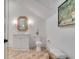 Bathroom features white vanity, woven details, and an artistic painting at 27 Watroo Pt, Daniel Island, SC 29492