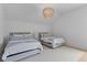This bedroom has two twin beds and stylish light fixture at 27 Watroo Pt, Daniel Island, SC 29492