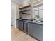 Butler's pantry featuring built in cabinets, shelving, wine cooler, and beverage refrigerator at 27 Watroo Pt, Daniel Island, SC 29492