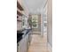 Butler's pantry featuring built in cabinets, shelving, wine cooler, and marble countertops at 27 Watroo Pt, Daniel Island, SC 29492