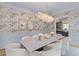 Dining room featuring wainscoting, art, wallpaper, marble table, and bubble chandelier at 27 Watroo Pt, Daniel Island, SC 29492