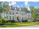 Charming two-story home with a manicured lawn and beautiful landscaping at 27 Watroo Pt, Daniel Island, SC 29492