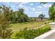 Scenic view of the golf course with lush greenery, mature trees, and a clear blue sky at 27 Watroo Pt, Daniel Island, SC 29492