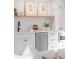 A kitchenette with white cabinets, countertops, a stainless steel dishwasher, and modern decor at 27 Watroo Pt, Daniel Island, SC 29492