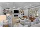 Cozy living room with built-in shelves, fireplace, and comfortable seating at 27 Watroo Pt, Daniel Island, SC 29492