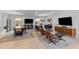 Bright living room featuring a TV, dining table and chairs, wood floors, and stylish modern furniture at 27 Watroo Pt, Daniel Island, SC 29492