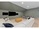 Spacious living room perfect for entertaining with a ping pong table, large sectional, and three televisions at 27 Watroo Pt, Daniel Island, SC 29492