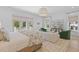 Bright, spacious primary bedroom with seating area, doors to balcony and natural light at 27 Watroo Pt, Daniel Island, SC 29492