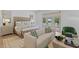 Bright bedroom featuring a seating area and access to a private balcony with golf course views at 27 Watroo Pt, Daniel Island, SC 29492