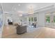 Spacious and luxurious bedroom suite with sitting area, tray ceiling, and bright natural light at 27 Watroo Pt, Daniel Island, SC 29492