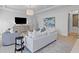 Bright main bedroom featuring a seating area, modern decor, and a large wall-mounted television at 27 Watroo Pt, Daniel Island, SC 29492