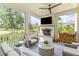 Inviting screened porch with a fireplace and comfortable outdoor seating at 27 Watroo Pt, Daniel Island, SC 29492