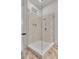 This shower has glass doors, white tile, and bronze fixtures at 27 Watroo Pt, Daniel Island, SC 29492