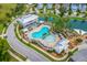 Community aerial view showcasing a sparkling pool, splash pad, pool house, and playgrounds at 2710 Mcfadden Way, Johns Island, SC 29455