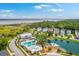 Aerial view showcasing community's pool, playground, and pond, nestled among beautiful landscaping at 2710 Mcfadden Way, Johns Island, SC 29455