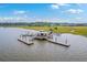 Aerial view of a waterfront property with a private dock, gazebo, boat slips and marsh surroundings at 2710 Mcfadden Way, Johns Island, SC 29455