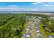 Aerial view showcasing neighborhood, wooded areas, and the Ravenel and Stono Rivers in the distance at 2710 Mcfadden Way, Johns Island, SC 29455