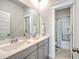 Well-lit bathroom features double sinks and a shower-tub combo at 2710 Mcfadden Way, Johns Island, SC 29455