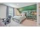Stylish bedroom with a decorative green accent wall and modern decor at 2710 Mcfadden Way, Johns Island, SC 29455