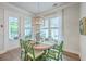 Light-filled dining room with wood floors, a round table, stylish chairs, and a view to the porch at 2710 Mcfadden Way, Johns Island, SC 29455