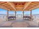 Interior view of a wooden gazebo with bench seating offering panoramic water views and open air at 2710 Mcfadden Way, Johns Island, SC 29455