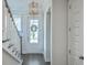 Inviting entryway with a modern light fixture and a view of the front door at 2710 Mcfadden Way, Johns Island, SC 29455