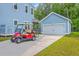 Home exterior with a matching detached garage and a red golf cart parked on the driveway at 2710 Mcfadden Way, Johns Island, SC 29455